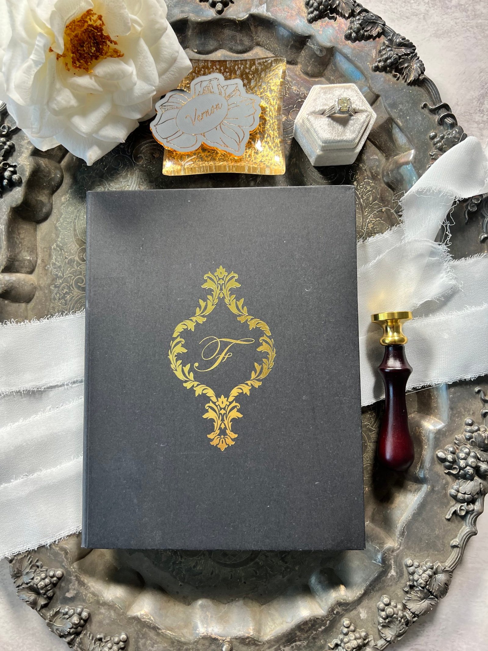 hard Damask bookfold invitation with black and gold foil